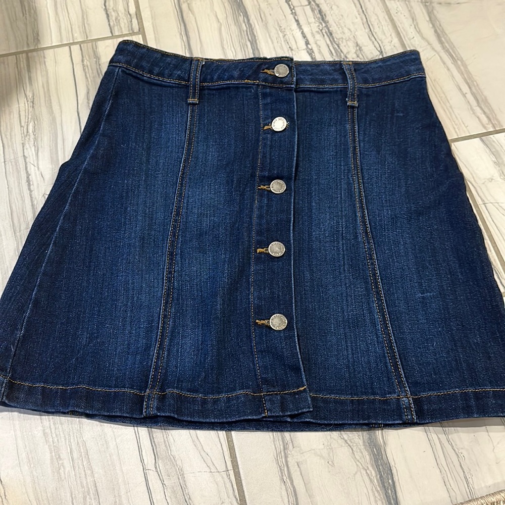 Medium dark blue Jean button up skirt.